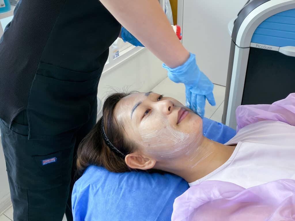 Applying numbing cream after facial wash.